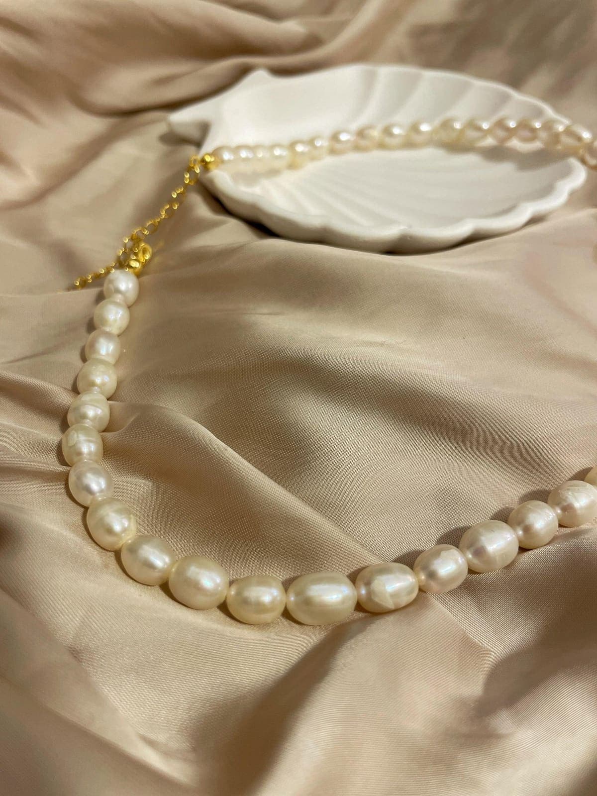 Freshwater pearl necklace on soft ivory fabric