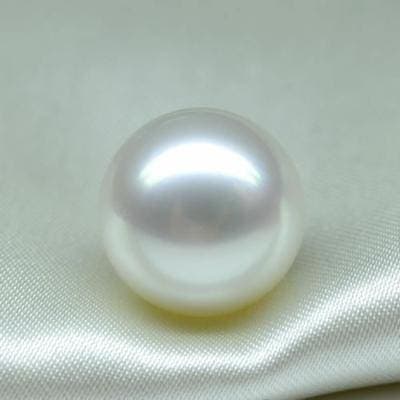 A lustrous pearl resting on satin