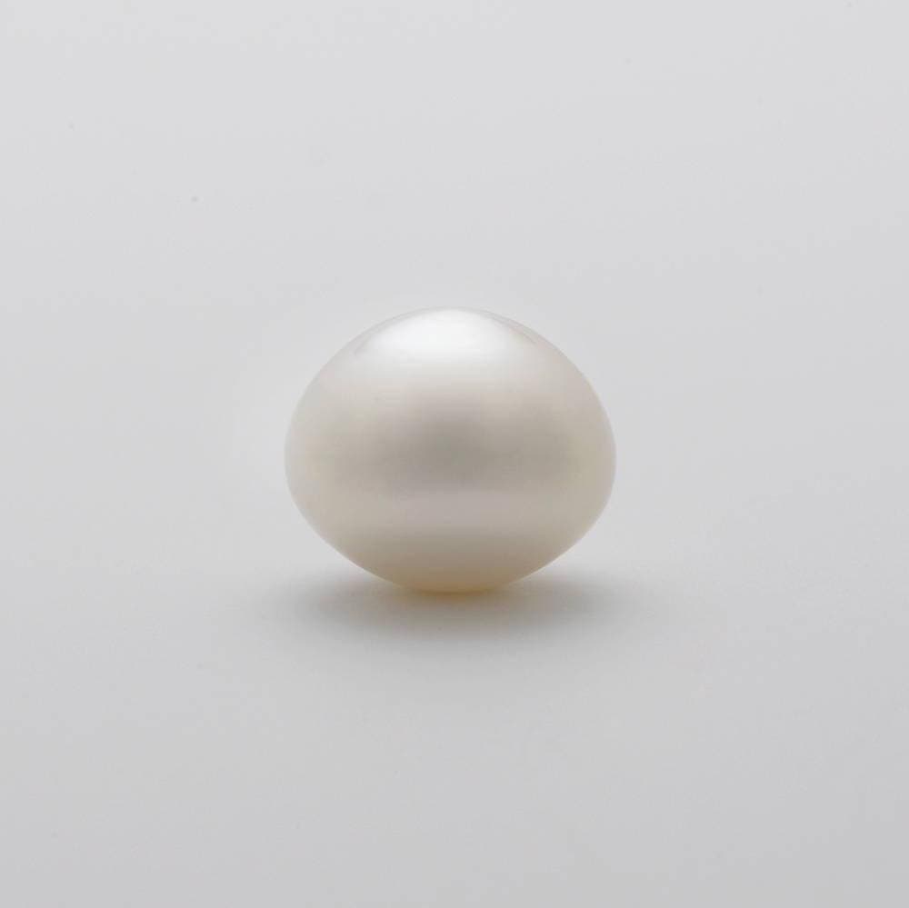 A button pearl, slightly flattened on one side