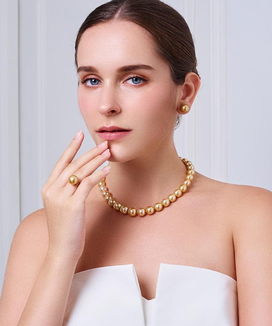 Golden South Sea pearl necklace and earrings worn with a white dress